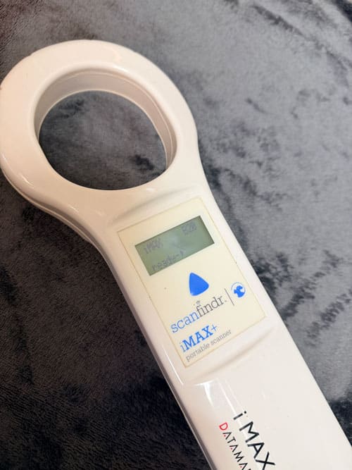 Handheld iMAX ScanFinder portable microchip scanner with LCD display and circular scanning head.